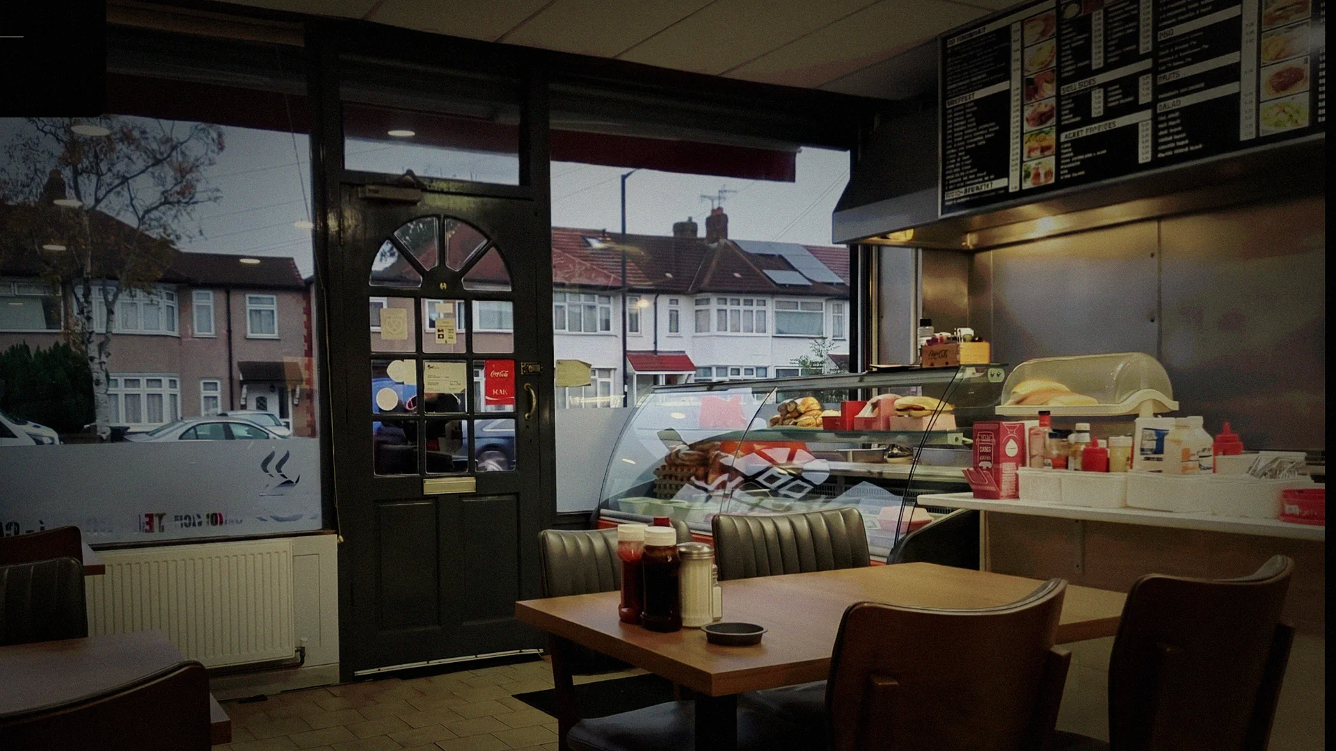 Nightingale Cafe interior — warm amber light, dark wood counters